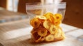 Crispy Plantain Chips Packed in Clear Plastic Bag Ready to Eat Snack on Kitchen Counter, AI generated Royalty Free Stock Photo