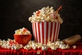 Crispy popcorn snack with striped bucket and corn kernels.