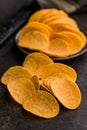 Crispy potato chips on black table Royalty Free Stock Photo