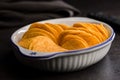 Crispy potato chips in bowl on black table Royalty Free Stock Photo