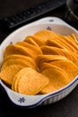 Crispy potato chips in bowl on black table Royalty Free Stock Photo