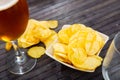 Potato chips served with glass of beer Royalty Free Stock Photo