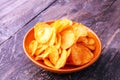 Crispy potato chips in a bowl. Tasty paprika chips