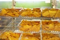 crispy potato chips with different flavors in plastic containers.
