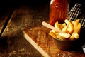 Crispy potato chips or wedges with ketchup Royalty Free Stock Photo