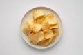 Crispy Potato Chips on a White Plate Top View Royalty Free Stock Photo