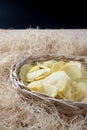 Crispy potato chips in a wicker bowl. Royalty Free Stock Photo