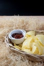 Crispy potato chips in a wicker bowl with ketchup. Royalty Free Stock Photo