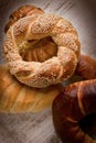 Crispy pretzel with sesame and bread on rustic table Royalty Free Stock Photo