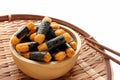 Crispy rice cakes wrapped in seaweed in a wooden bowl. Nori maki rice crackers. Royalty Free Stock Photo