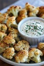 Crispy roasted cauliflower bites with creamy dip for delicious appetizer or snack Royalty Free Stock Photo
