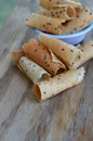 Crispy rolled wafer traditional Thai dessert on wooden table