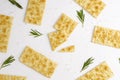 Crispy rosemary crackers on white background.