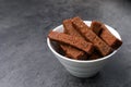 Crispy rusks in bowl on grey table, closeup Royalty Free Stock Photo