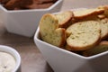 Crispy rusks in bowl on wooden table, closeup Royalty Free Stock Photo
