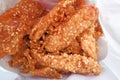 Crispy sesame fried banana in a food bag - Traditional Asian food.