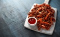 Crispy shredded beef with carrots and sweet chilli sauce on white wooden board. Chinese takeaway food Royalty Free Stock Photo