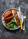 Crispy spice crust baked salmon with sweet potato and spinach - healthy balanced lunch on dark background, top view Royalty Free Stock Photo