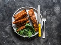 Crispy spice crust baked salmon with sweet potato and spinach - healthy balanced lunch on dark background, top view Royalty Free Stock Photo