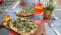 crispy, spritz, pinsa with raw ham and arugula, small pizza with sausage and broccoli, Italian pastry, Roman specialty Royalty Free Stock Photo