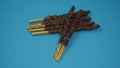Crispy sticks with hazelnut sprinkles in chocolate on a blue background. Royalty Free Stock Photo