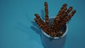 Crispy sticks with hazelnut sprinkles in chocolate on a blue background. Royalty Free Stock Photo