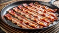 Crispy strips of bacon frying on a cast iron griddle pan Royalty Free Stock Photo