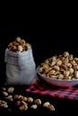 Crispy Sugared peanuts in Sack and white cup Royalty Free Stock Photo
