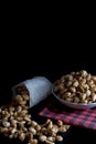 Crispy Sugared peanuts in Sack and white cup Royalty Free Stock Photo