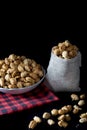Crispy Sugared peanuts in Sack and white cup Royalty Free Stock Photo