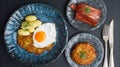 Crispy swiss rosti potato cake served with a fried egg and bacon on a rustic table in a cozy kitchen setting Royalty Free Stock Photo