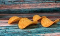 Crispy thin potato chips on a blue background