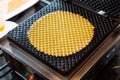 Crispy thin waffle bowl inside iron machine Royalty Free Stock Photo