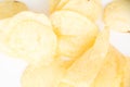 Crispy thinly sliced potato chips closeup, on white Royalty Free Stock Photo