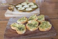 Crispy toasted bread with garlic butter and dill on wooden plate