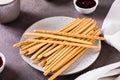 Crispy toasted sweet straws with berry jam on a plate for dessert