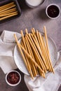 Crispy toasted sweet straws with berry jam on a plate for dessert. Top and vertical view