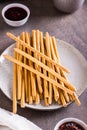 Crispy toasted sweet straws with berry jam on a plate for dessert. Vertical view