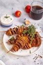 Crispy tornado potatoes. Potato chips on skewers, roasted with thyme and spices