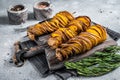 Crispy Tornado or twist potatoes chips on wooden board. Gray background. Top view