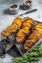 Crispy Tornado or twist potatoes chips on wooden board. Gray background. Top view