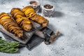 Crispy Tornado or twist potatoes chips on wooden board. Gray background. Top view. Copy space