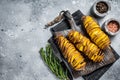 Crispy Tornado or twist potatoes chips on wooden board. Gray background. Top view. Copy space