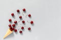 Crispy waffle ice cream cone with scattered red ripe sweet cherries. Still life on grey background. Copy space, Flat lay, Top view Royalty Free Stock Photo