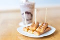 Crispy waffles with honey on a white plate serve with iced blend