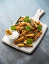 Crispy zucchini fries with sauce in white wooden board