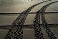 Criss cross 4WD vehicle tyre tracks on a beach, New Zealand Royalty Free Stock Photo