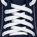 Criss-cross white lacing in new trendy dark blue sports shoe Royalty Free Stock Photo