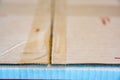 Criss crossing clear tape lines closing a white flat rate box for shipping in the mail Royalty Free Stock Photo