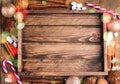 Cristmas background with place for text Topp view Wooden background Wooden tray Cookies Candy cane Cinnamon sticks Christmas card
